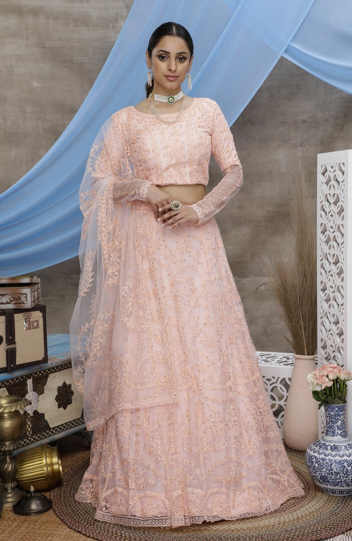 Peach net heavy embroidered wedding lehenga choli