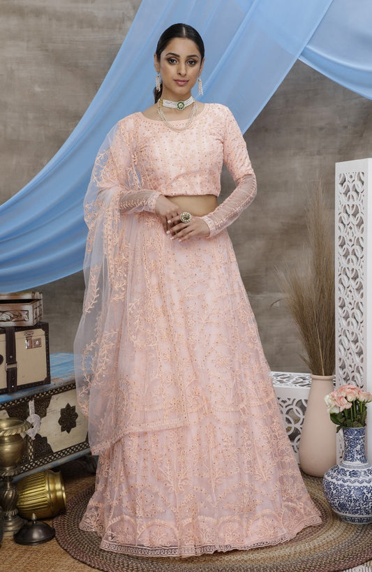 Peach net heavy embroidered wedding lehenga choli