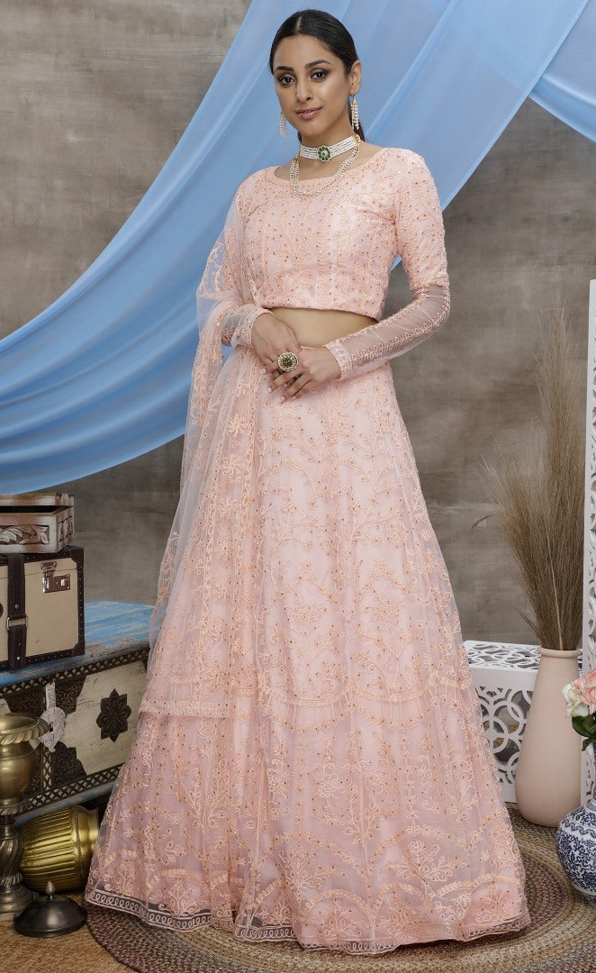 Peach net heavy embroidered wedding lehenga choli