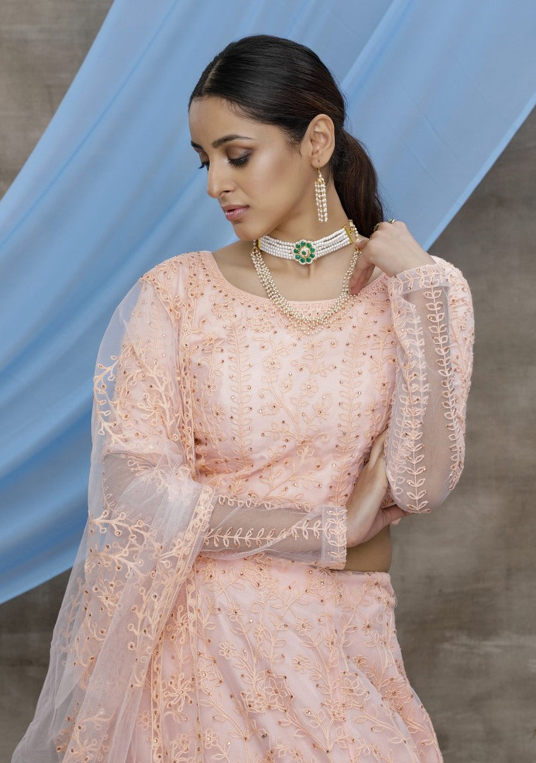 Peach net heavy embroidered wedding lehenga choli