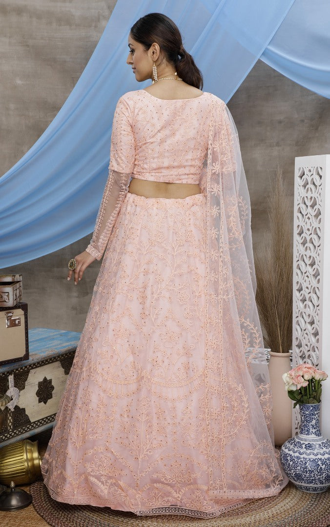 Peach net heavy embroidered wedding lehenga choli
