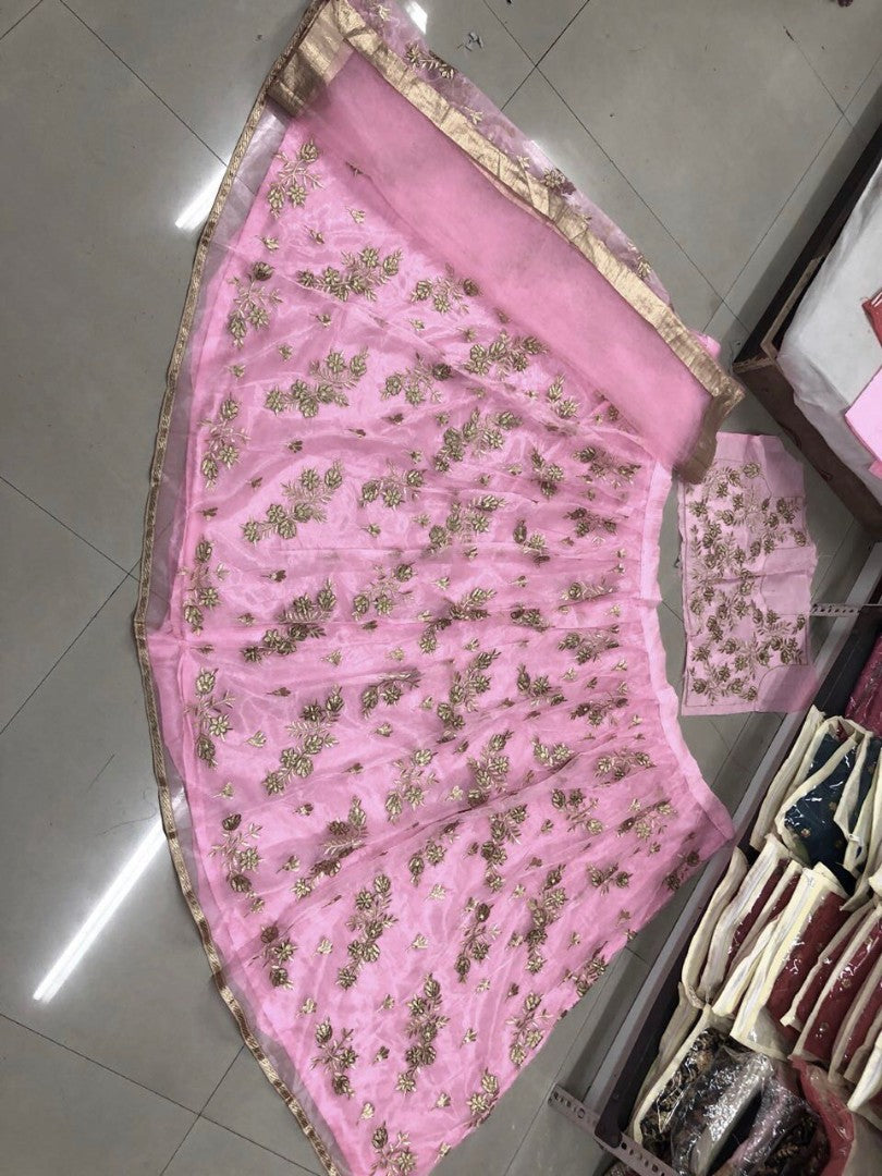 Pink net heavy embroidered wedding lehenga