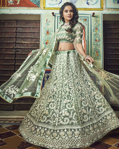 Pista green soft net thread and pearl work bridal lehenga choli