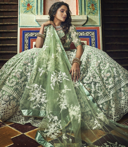 Pista green soft net thread and pearl work bridal lehenga choli