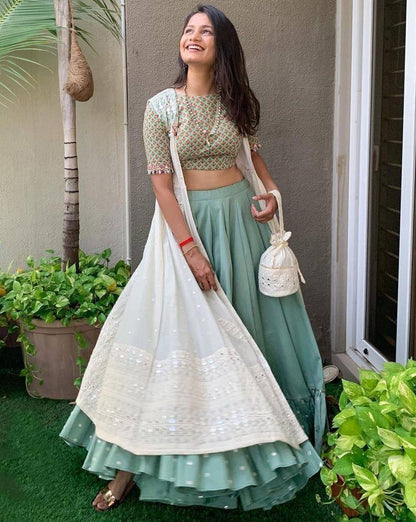 Sea green ruffle border indowestern lehenga with white embroidered shrug