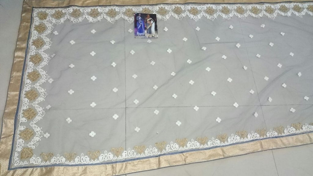 shriya nylon net white saree with heavy blouse