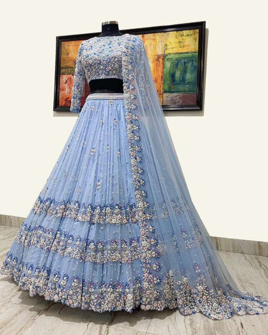Sky blue net heavy embroidered ceremonial lehenga choli