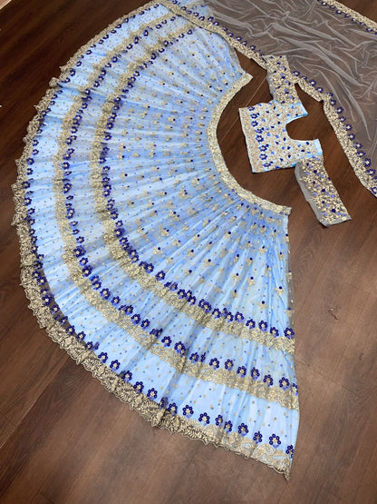 Sky blue net heavy embroidered ceremonial lehenga choli