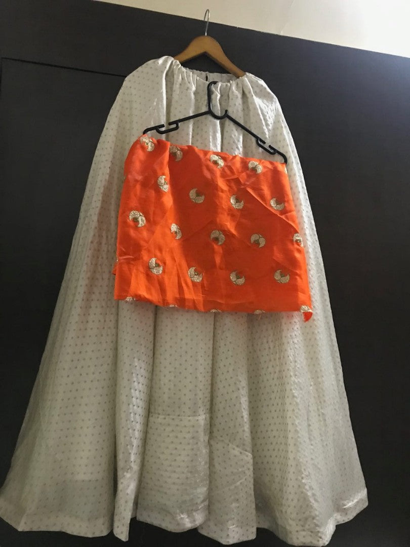white heavy banarasi jacquard silk crop top lehenga with orange top