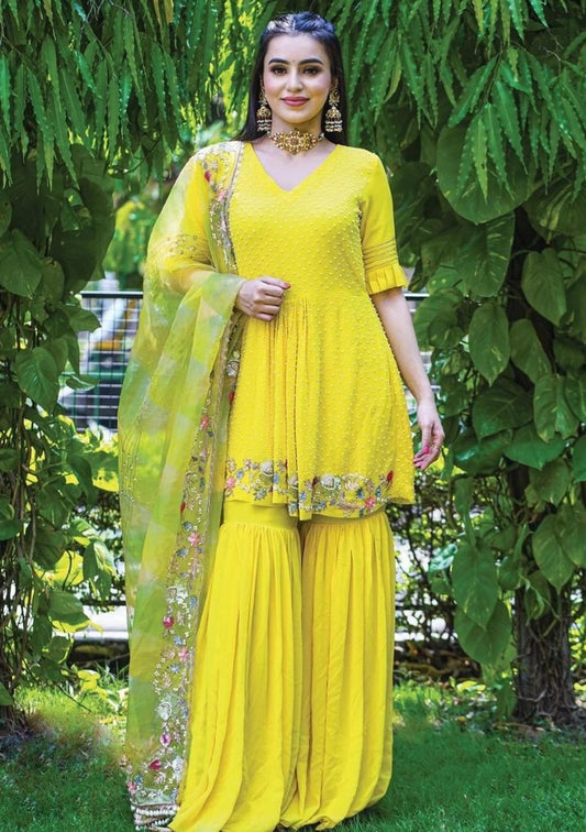Yellow georgette embroidered and moti work sharara suit