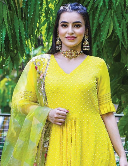 Yellow georgette embroidered and moti work sharara suit
