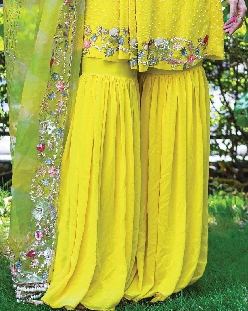 Yellow georgette embroidered and moti work sharara suit