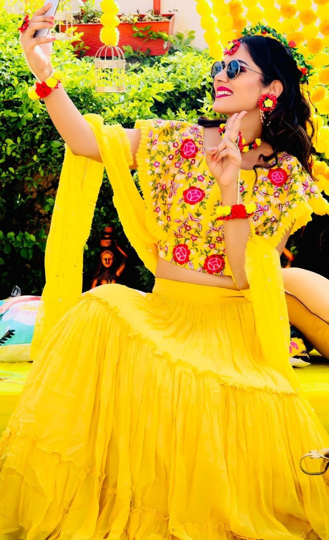 Yellow georgette embroidered ruffle lehenga for haldi ceremony