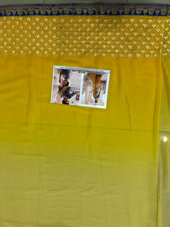 Yellow georgette embroidered wedding saree with heavy blouse