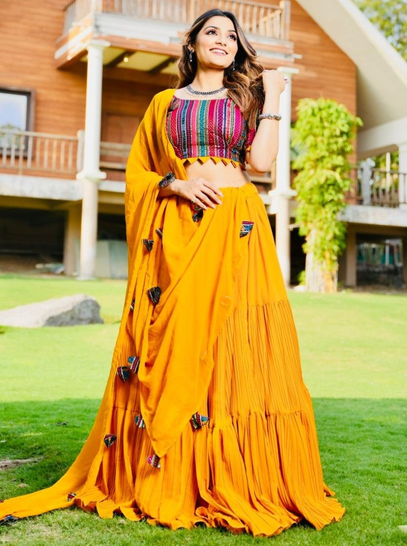 Yellow georgette ruffle layer lehenga with embroidered choli