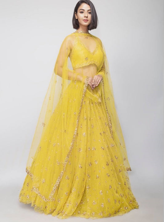 Yellow net embroidery work lehenga choli for haldi ceremony
