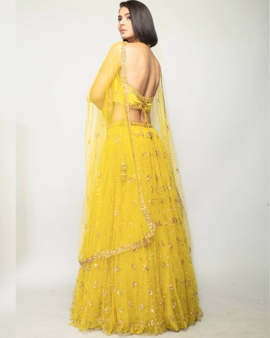 Yellow net embroidery work lehenga choli for haldi ceremony