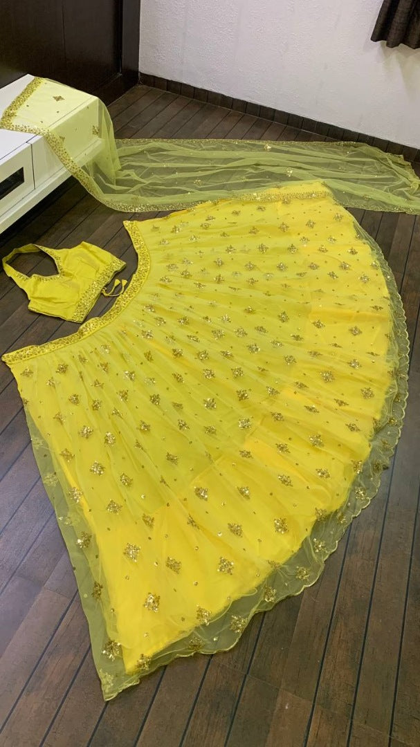 Yellow net embroidery work lehenga choli for haldi ceremony