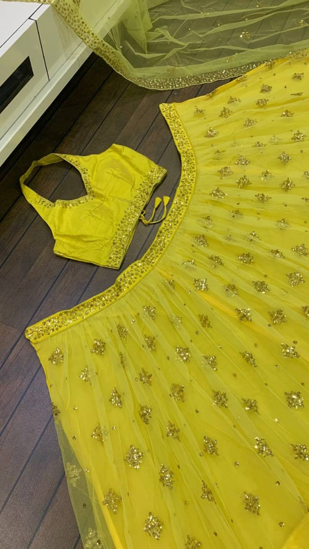 Yellow net embroidery work lehenga choli for haldi ceremony