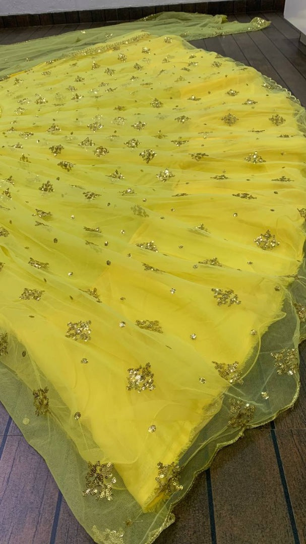 Yellow net embroidery work lehenga choli for haldi ceremony