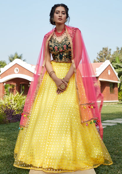 Yellow net metallic foil printed work party wear lehenga choli