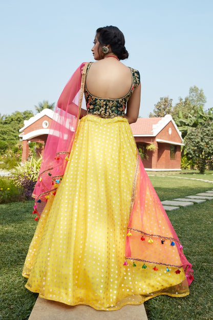 Yellow net metallic foil printed work party wear lehenga choli