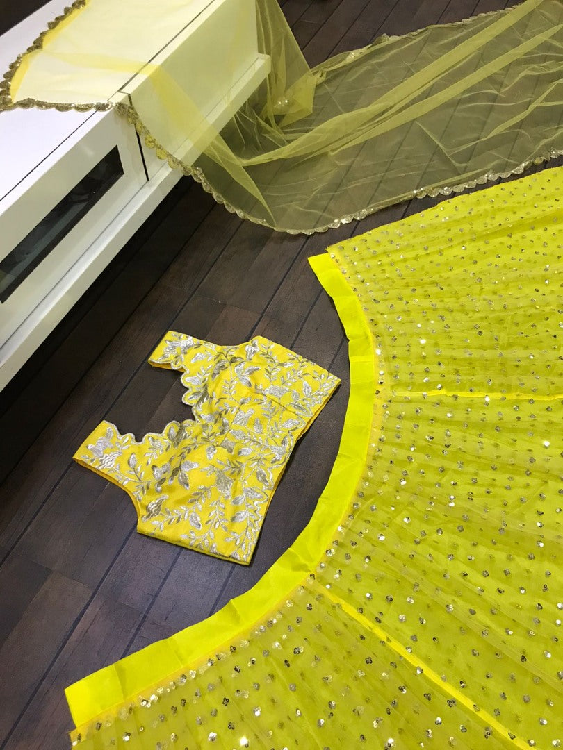 Yellow net sequence and thread embroidered ceremonial lehenga choli