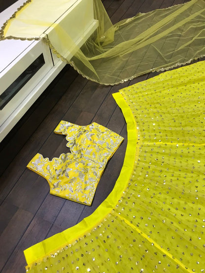 Yellow net sequence and thread embroidered ceremonial lehenga choli