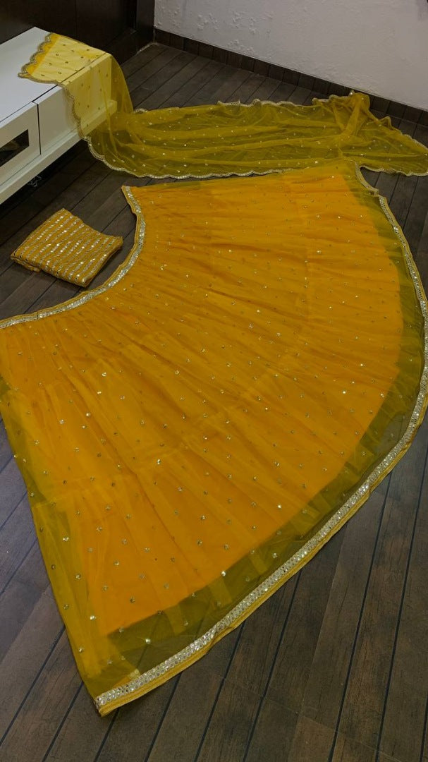 Yellow net sequence embroidery work ruffle lehenga choli for ceremony