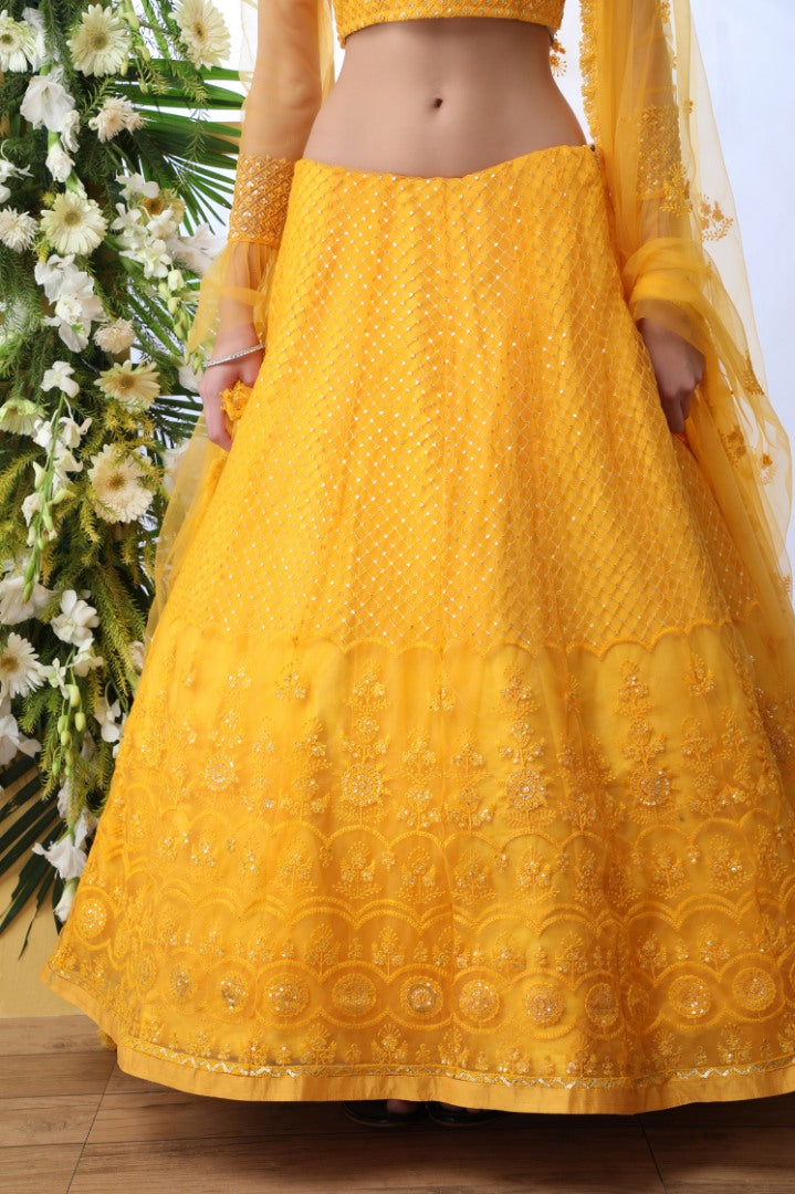 Yellow net thread and sequence embroidered wedding lehenga choli