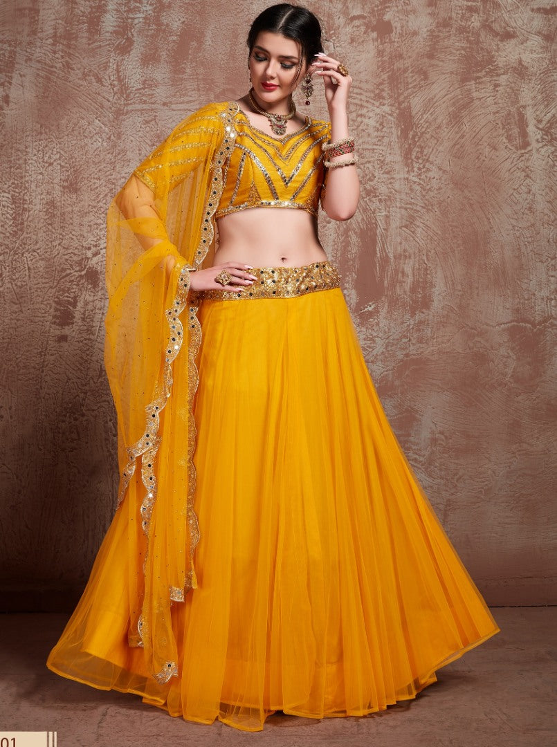 Yellow soft silk ceremonial lehenga choli with mirror work blouse