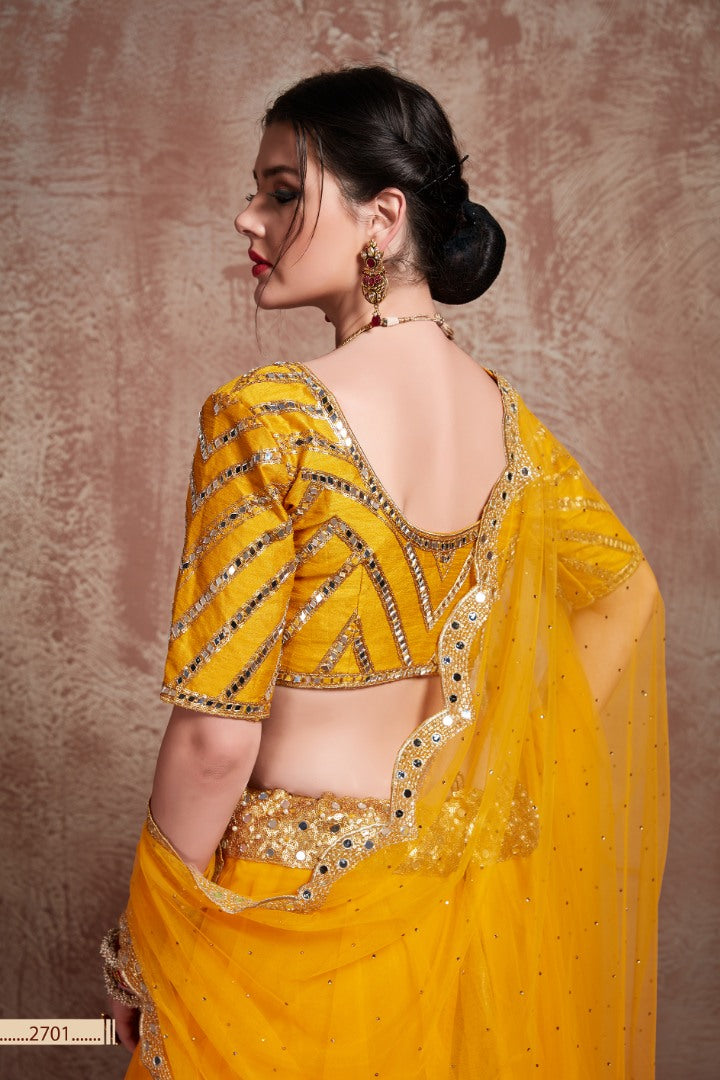 Yellow soft silk ceremonial lehenga choli with mirror work blouse